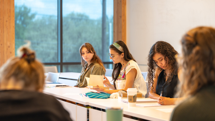 Students read and write during a class in Dicke Hall.