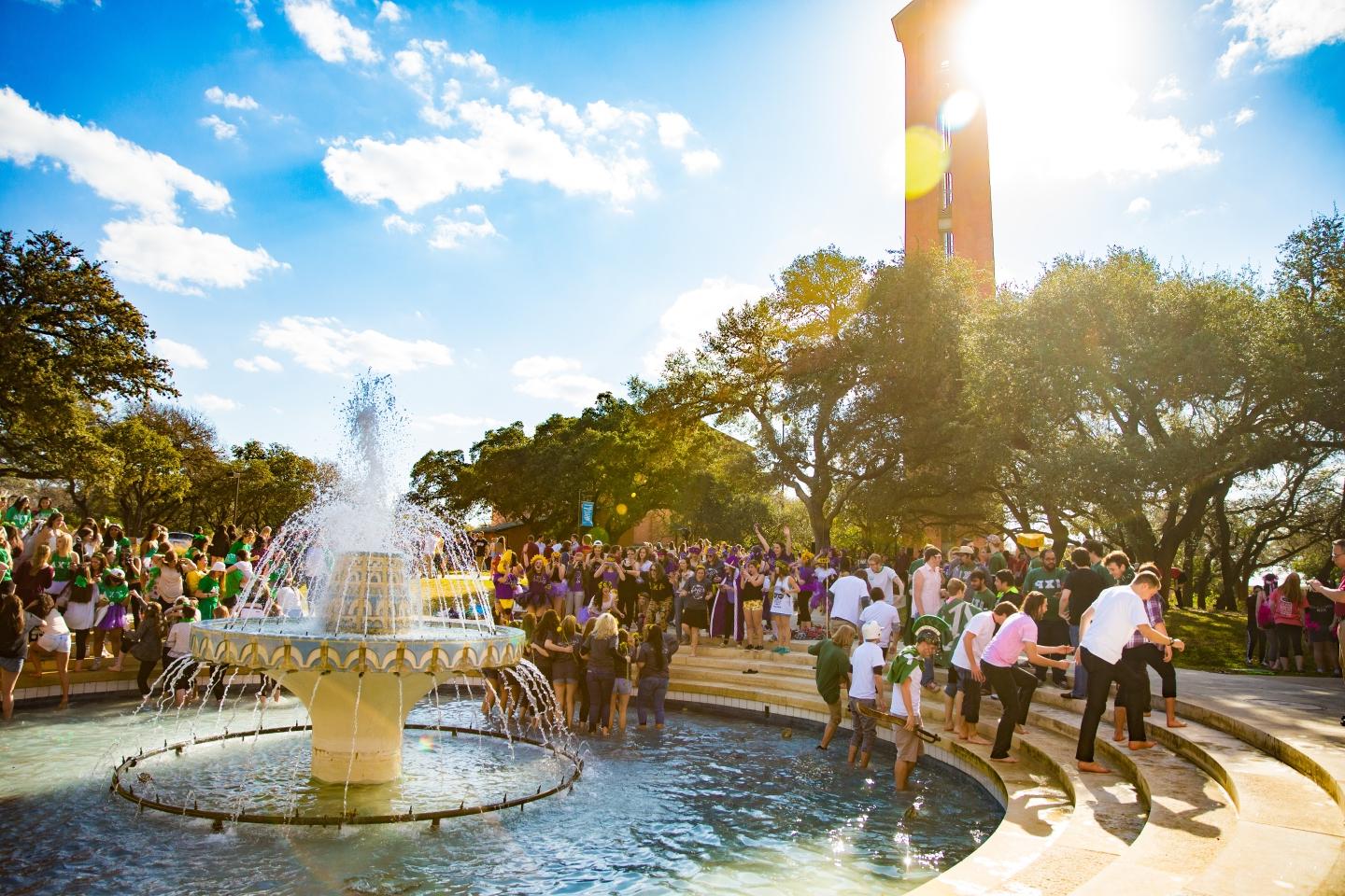 Dozens of Fraternity and Sorority members gather in Miller Fountain during a sunny Bid Day