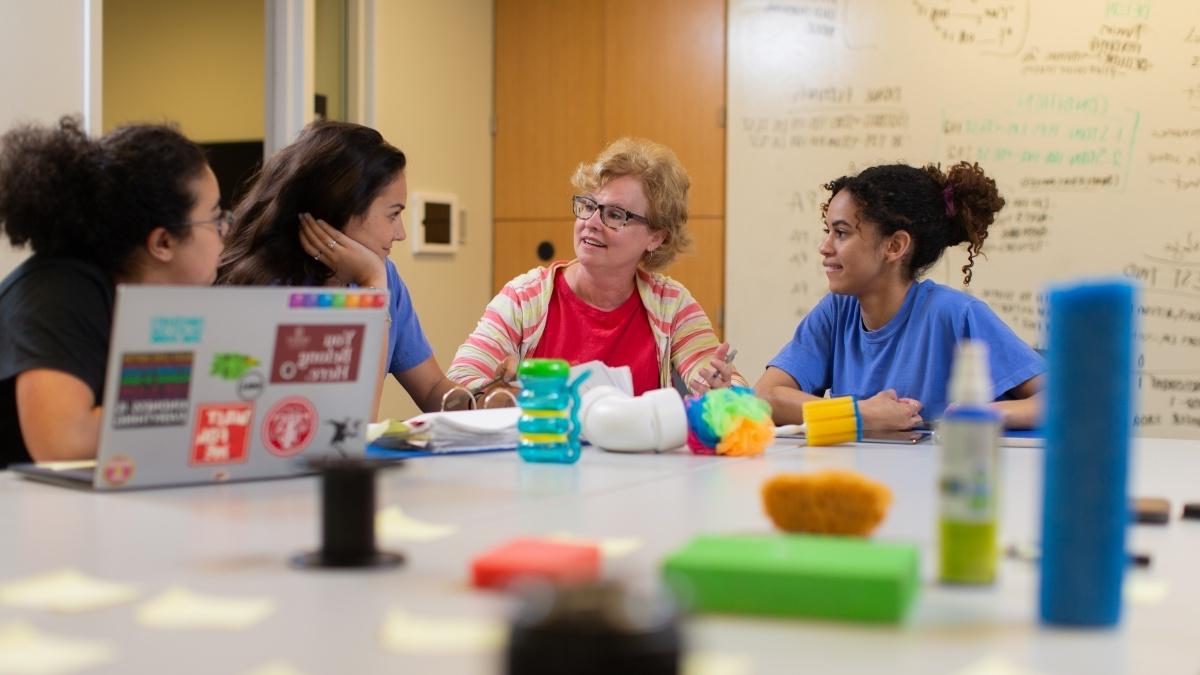 group of people sitting around a table with manipulatives (objects to be manipulated)